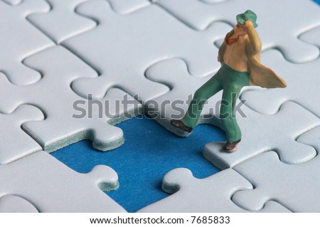 plastic figure falls into a puzzle hole