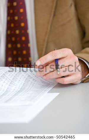 Line Manager with red necktie and pen in his hand