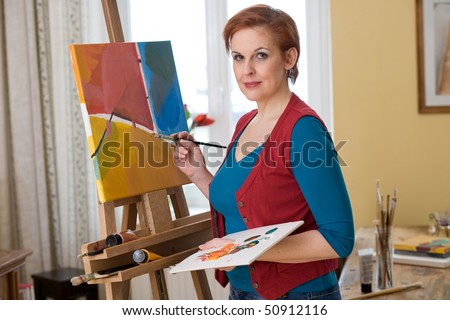 female artist painting in her living room