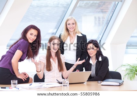 smart women in business outfit sitting in front of the window