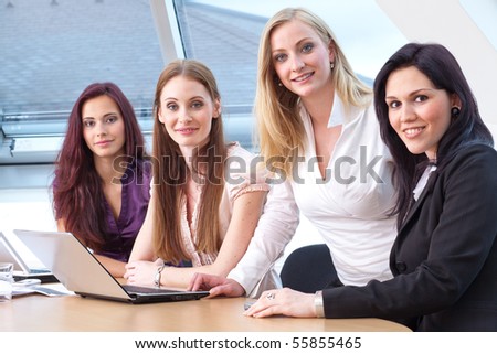 young female boss and employees during work
