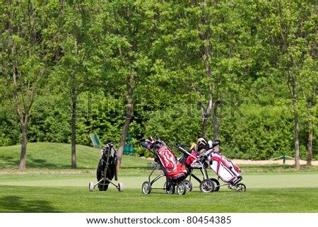 golf equipment is standing on the golf course