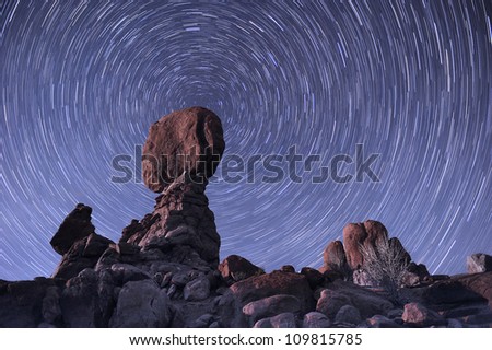 The stars spin around the balance rock formation at Arches National Park, USA