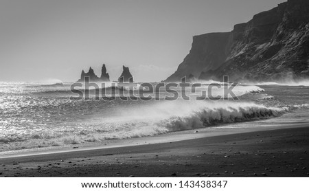 Waves crash into the rocky black beaches near Vik, Iceland.