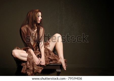 Beautiful woman wearing scarf sitting