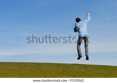 Man on hill jumping up