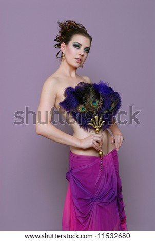 Beautiful Woman covered with feather fan