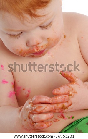 Messy baby with icing on hands and face