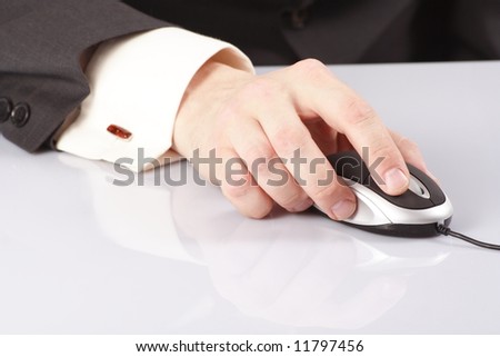 Computer mouse in business hand isolated on white