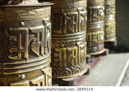 prayer wheels in front of temple in thailand