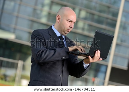 business man with laptop outside
