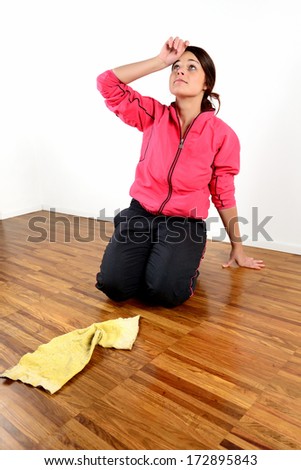 Tired girl mopping the floor