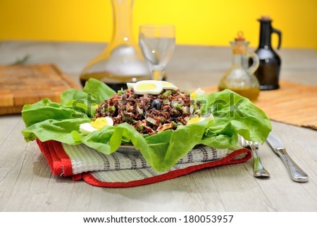 red rice salad on lettuce leaves