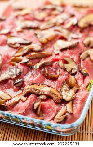 raw meat carpaccio with mushrooms