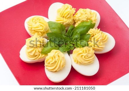 stuffed eggs with mayonnaise on a red plate