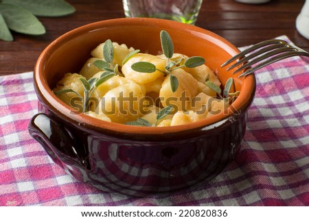 Gnocchi with butter and sage in a terracotta bowl
