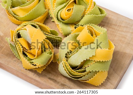 Italian colored pasta raw straw and hay isolated on a white background