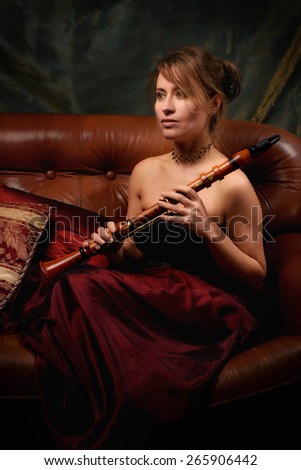 Woman in ancient costume with a clarinet vintage