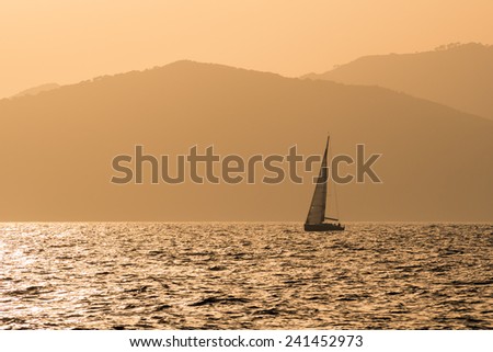 Small yacht at the sunset at the coast