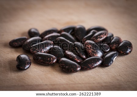 Celebration runner beans dried ready for sowing, on wooden board