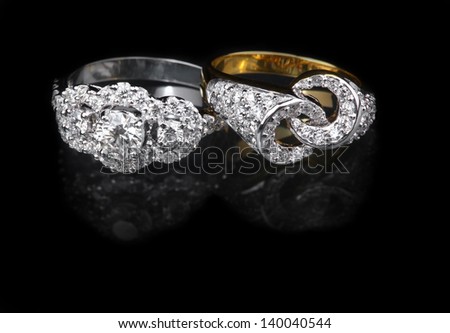 White gold diamond ring and Golden diamond ring on black background