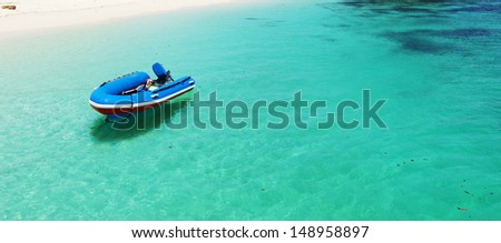 Boat on clear aqua water, fresh feeling