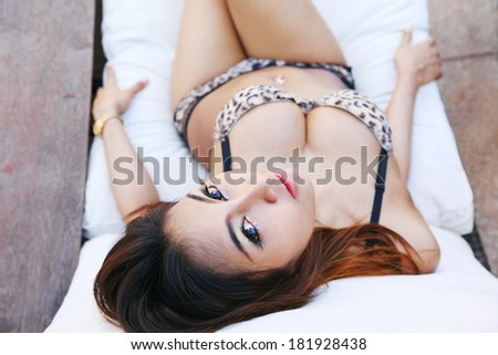 Sexy bikini young woman on deck chair