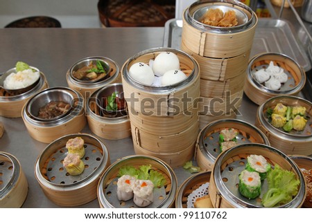 Steamed stuff bun and many chinese steamed dimsum in bamboo containers traditional cuisine.
