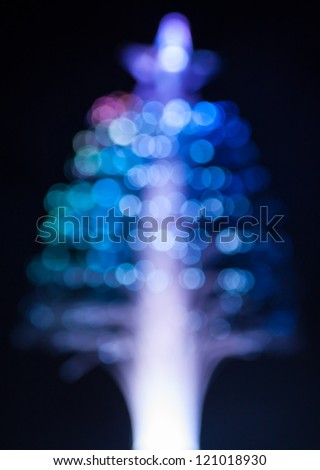 Blue fiber optic Christmas tree light on black background. Shallow depth of field.