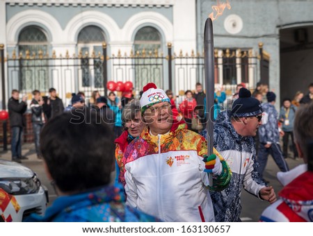 VLADIVOSTOK, RUSSIA - NOVEMBER 16: torchbearer carries the Olympic flame in relay of Olympic Flame on November, 2013 in Vladivostok, Russia.