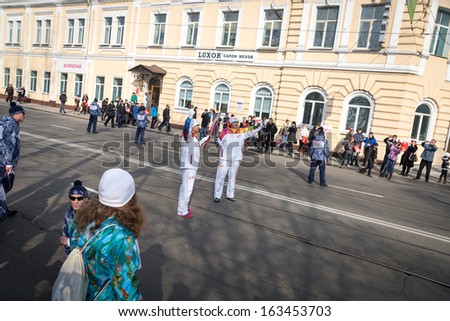VLADIVOSTOK, RUSSIA - NOVEMBER 16: torchbearer carries the Olympic flame in relay of Olympic Flame on November 16, 2013 in Vladivostok, Russia.