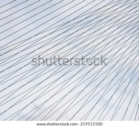Steel cables over sky background.