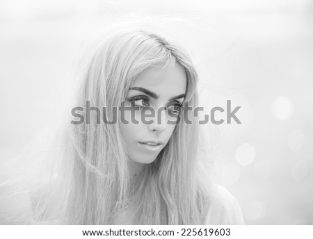 Black and white portrait of a beautiful blonde girl close-up. Shallow depth of field.