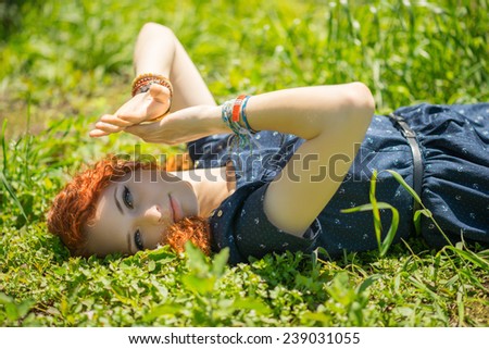 Young beautiful girl closed her eyes from the sun by hand.