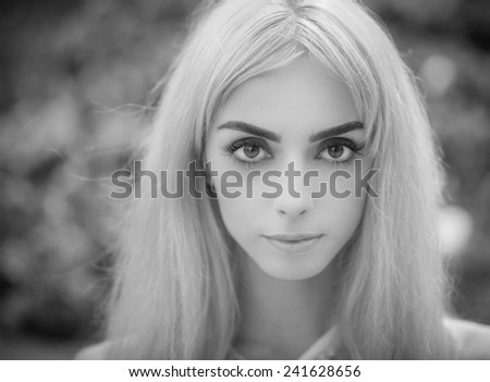 Black and white portrait of a beautiful blonde girl close-up. Shallow depth of field.