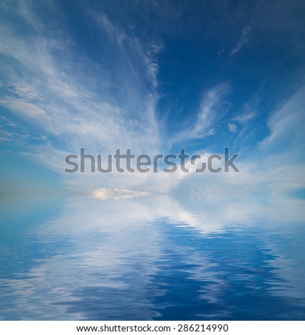 Sky with clouds reflected in water surface.