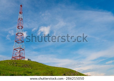 Telecommunications tower over blue sky background.