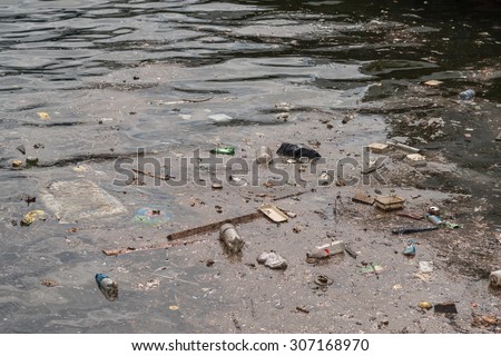 Oil and garbage pollution in the water. Selective focus with shallow depth of field.