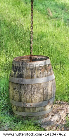 old wooden rain barrel with chain, Wales