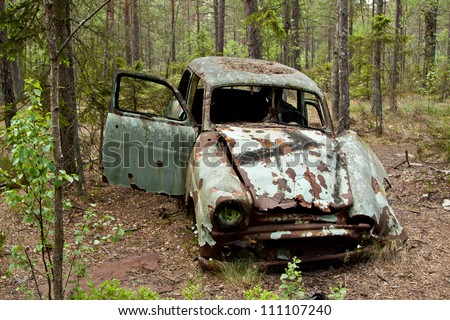 Old rusted car in junk yard