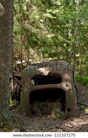 Old rusted car in junk yard