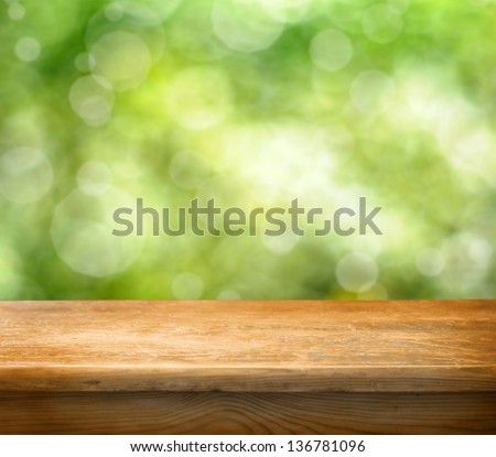 Wooden Table With Space For Your Photo Montage And Green Color Of Background