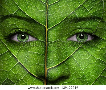 Woman face with leaf texture and green eyes. Ecology concept.