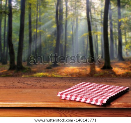 Empty wooden table in  autumn forest. Great background for product display.