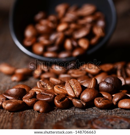 Macro shot of coffee beans on wooden background