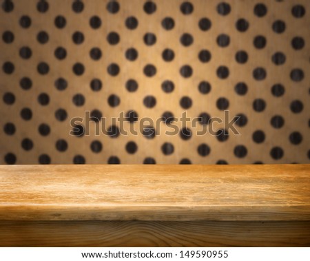 Empty checkered table and wall with black dots.