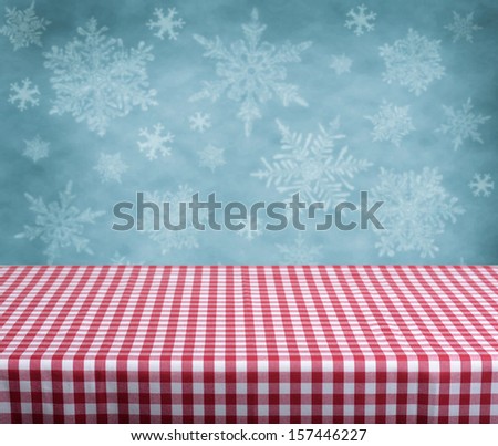 Empty table with red gingham tablecloth over blue background. Great for product display montages