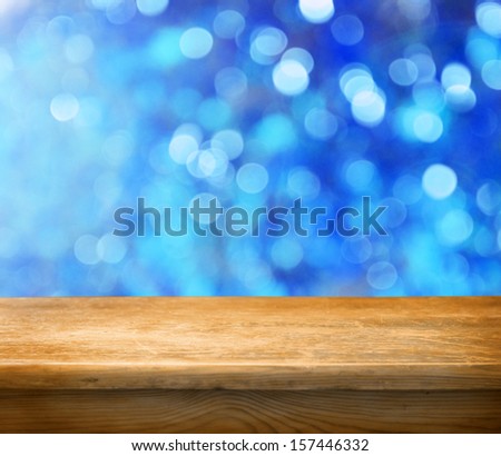 Empty wooden deck table with winter bokeh background. Ready for product display montage.