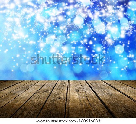 Empty wooden deck table with winter bokeh background. Ready for product display montage.