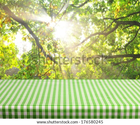 Empty table and defocused forest dawn inbackground